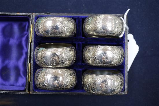 A cased set of six late Victorian silver napkin rings, Birmingham, 1897, a later pair and two other napkin rings.